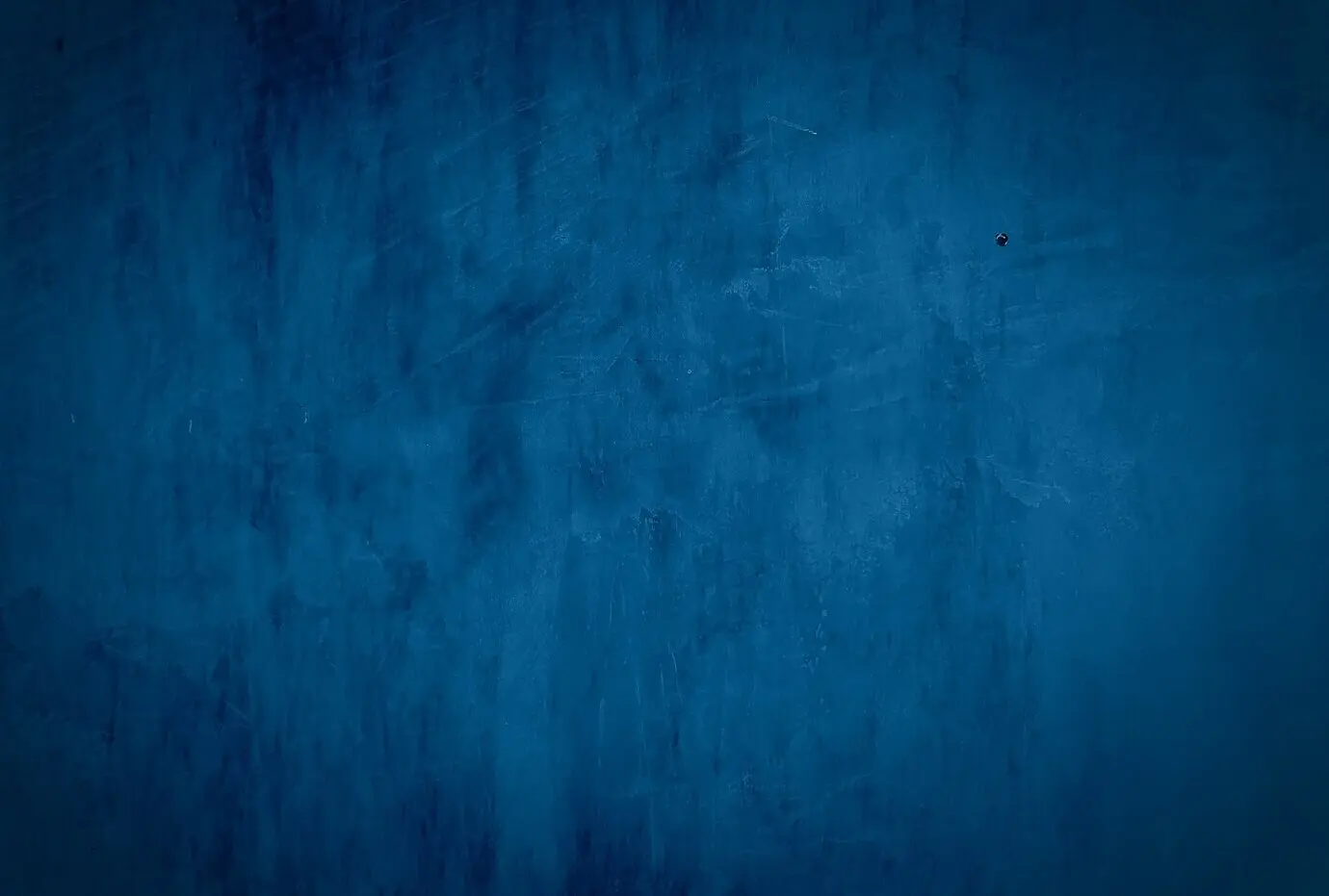 Studio-Wandhintergrund mit blauer Betontextur im Vintage-Grunge-Stil mit Vignette.